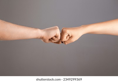 Man and woman are fist bumping. Fist Bump. Clash of two fists, vs. Gesture of giving respect or approval. Friends greeting. Teamwork and friendship. Partnership concept. Male vs female hand. - Powered by Shutterstock