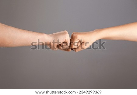 Man and woman are fist bumping. Fist Bump. Clash of two fists, vs. Gesture of giving respect or approval. Friends greeting. Teamwork and friendship. Partnership concept. Male vs female hand. Foto d'archivio © 