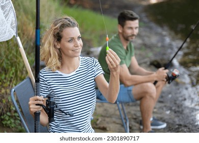 man and woman fly fishing in river - Powered by Shutterstock