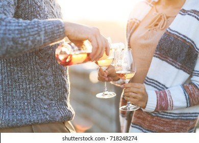 Man and woman with glass of rose wine on summer beach picnic - Powered by Shutterstock