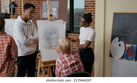 Man And Woman Guiding Elder Person To Draw Vase On Canvas, Giving Advice To Teach New Drawing Skills. Senior Student Attending Art Class Lesson For Personal Growth And Development.