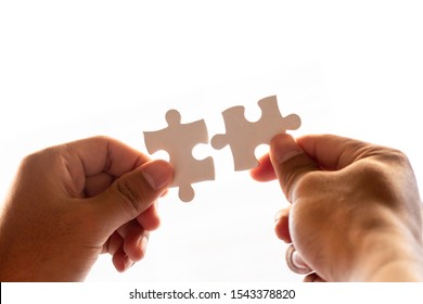 man and woman hand holding jigsaw puzzles, business matching concept - Shutterstock ID 1543378820