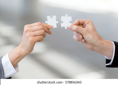 man and woman hand holding jigsaw puzzles, business matching concept - Shutterstock ID 578856343