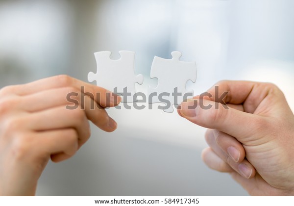 man and woman hand holding jigsaw puzzles,\
business matching concept