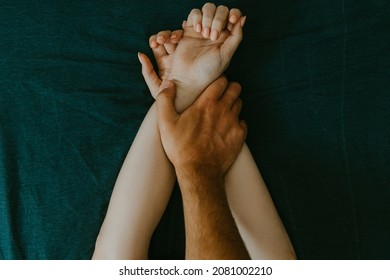 man and woman hands having sex on a bed. make love.