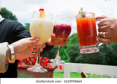 Man And Woman Hands Making Toast With Alcoholic Drinks Outdoors, Drinks Prepared By Bar Tender In Guatemala.