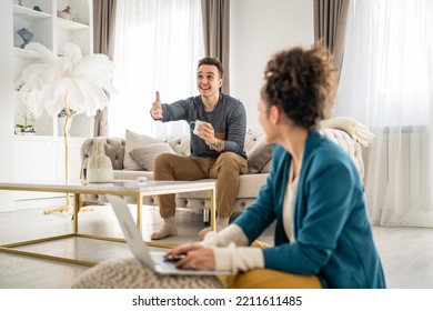 Man And Woman Happy Caucasian Couple Sitting At Home Chatting And Talking In Bright Room In Day Real People Family Concept Copy Space Young Adult Husband And Wife Having Conversation