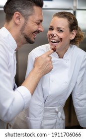 Man And Woman Having Fun With Chocolate In Icecream Factory