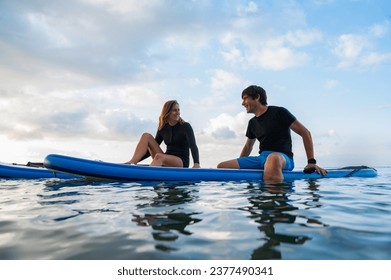 Man, woman, having fun practice paddle surf in Spain - Powered by Shutterstock