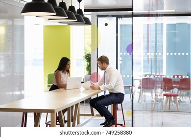 Man And Woman Having An Informal Meeting At Work