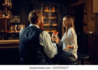 Man and woman having nice conversation at bar counter - Powered by Shutterstock