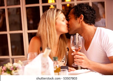 A man and woman having a romantic meal in an outdoor cafe - Powered by Shutterstock