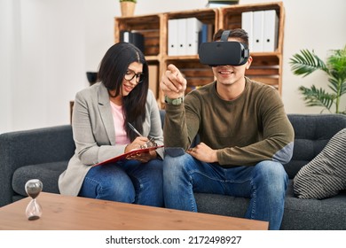 Man And Woman Having Virtual Reality Psychology Session At Clinic