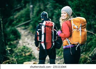 Man and woman hikers trekking in mountains. Young couple walking with backpacks in forest, Tatras in Poland. Old vintage photo style. - Powered by Shutterstock