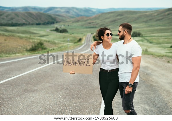 A man and a woman are hitchhiking. A young couple\
goes hitchhiking around the country. Free hitchhiking trip. A lover\
who travels free by hitchhiking. The couple goes traveling. Couple\
by the road