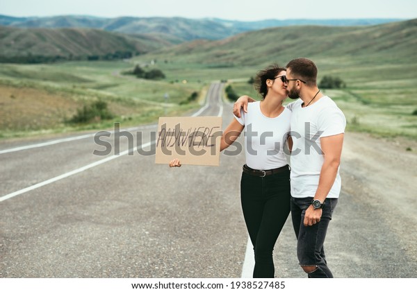 A\
man and a woman are hitchhiking. A young couple goes hitchhiking\
around the country. Free hitchhiking trip. A lover who travels free\
by hitchhiking. The couple goes traveling. Copy\
space