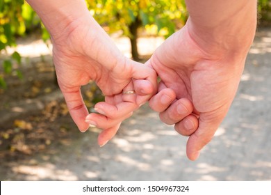 Man and woman hold hands. Hands of a couple finger by finger close-up. - Shutterstock ID 1504967324