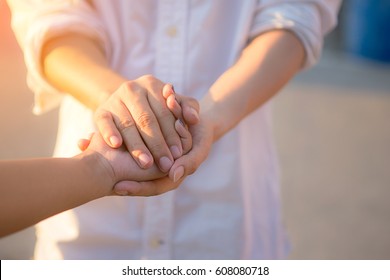 Man and woman holding hands closeup