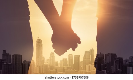 Man And Woman Holding Hands Standing Strong Together Facing The City. People Unity, Love And Relationships. Double Exposure.  