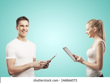 man and woman holding tablet on green background - Powered by Shutterstock