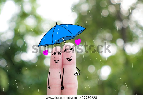 A man and a woman hug\
with pink hearts in the eyes. The concept of love at first\
sight.rainy season\
