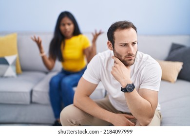 Man and woman interracial couple arguing at home - Shutterstock ID 2184097999