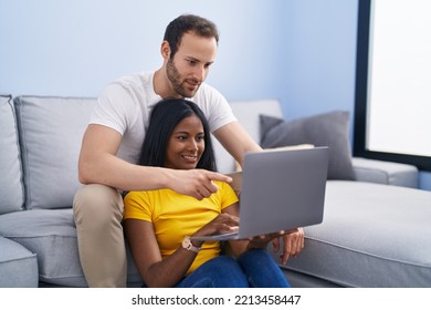 Man And Woman Interracial Couple Using Laptop At Home