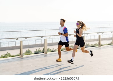 A Man and Woman Jog Along a Coastal Walkway During a Sunny Morning by the Sea - Powered by Shutterstock