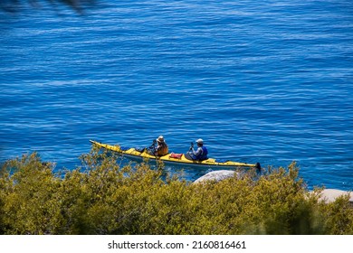 Man And Woman In Kayak Near To Shore On Sunny Day At Lake Tahoe.