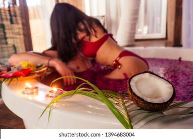 man and woman kissing and hugging romantic fruits, candles and champagne.sex in the water