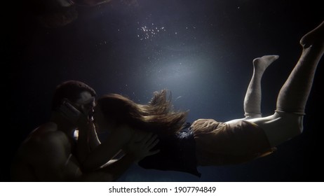 Man And Woman Are Kissing Underwater, Slow Motion Shot, Moving To Each Other And Back