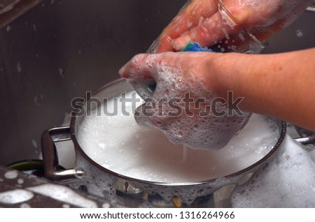 man woman in the kitchen at home washing dishes for cooking visible faucet water hands dishes