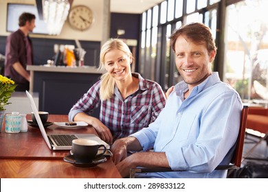 Man And Woman With Laptop At A Coffee Shop