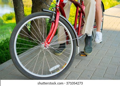 Man And Woman Legs, A Couple, Riding Together Tandem Bike In Park