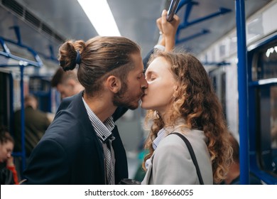 Man And A Woman In Love Kiss On A Subway Train.