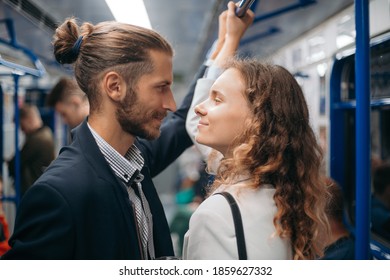 Man And Woman In Love Looking At Each Other On A Subway Train.