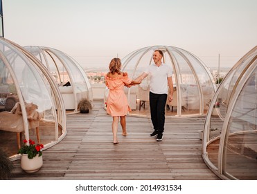 a man and a woman in love walk to a rooftop cafe on a date. original place for meeting and dinner. the anniversary of the relationship.  - Powered by Shutterstock