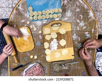 Man And Woman Making Dumplings Top View