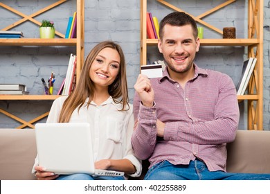 Man and woman making internet shopping with laptop and bank card
