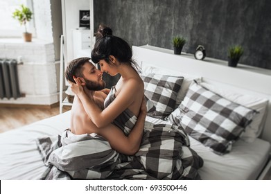 Man and woman making love in bed. Loving couple in bed having sex. Couple in bed. Wedding night. Make love. Lovers in bed. The relationship between a man and a woman. Sex between a man and a woman.