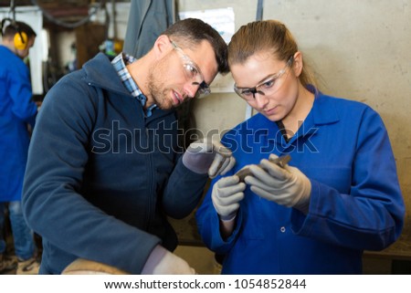 man and woman mechanics atwork