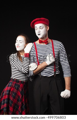Man and woman mimes together on isolated black background 