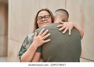 Man and woman mother and daugther hugging each other at street - Powered by Shutterstock