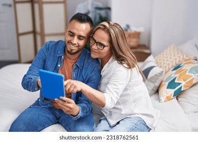 Man and woman mother and son using touchpad at bedroom - Powered by Shutterstock