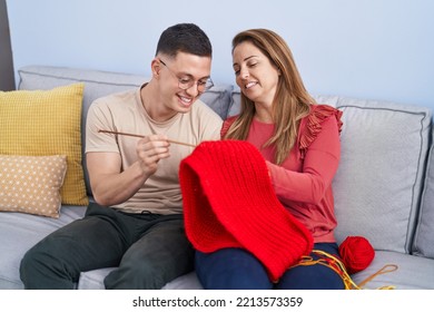 Man And Woman Mother And Son Weaving Wool Scarf At Home