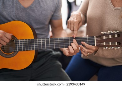 Man And Woman Musicians Having Classic Guitar Lesson At Music Studio