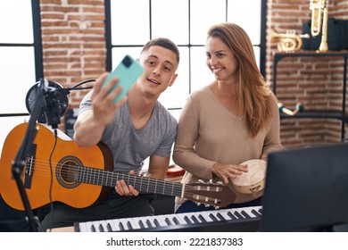 Man And Woman Musicians Having Classic Guitar Lesson Make Selfie By The Smartphone At Music Studio