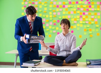 Man and woman in the office with many conflicting priorities in 
