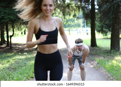 Man and woman on morning run in summer park. Cardio training is aimed at strengthening heart and increasing stamina. Motivation for morning run to tighten the body. Positive emotions from sports. - Shutterstock ID 1649396515