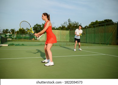 Man and woman on tennis training, outdoor court